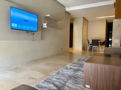 a living room with a flat screen tv on a wall at Résidence Prestigia Fès centre - 3 chambres in Fès