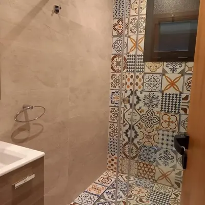 a bathroom with a shower with tiles on the wall at Villa Imane in Marrakech private pool in El Aouina