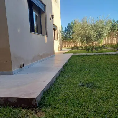 a concrete walkway next to a building with a window at Villa Imane in Marrakech private pool in El Aouina