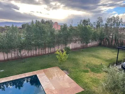a yard with a fence and a swimming pool at Villa Imane in Marrakech private pool in El Aouina