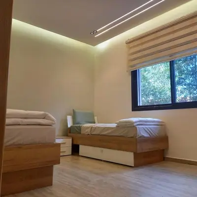 a bedroom with two beds and a window at Villa Imane in Marrakech private pool in El Aouina