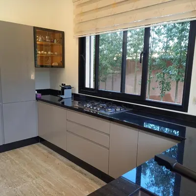 a kitchen with a counter with a stove and a window at Villa Imane in Marrakech private pool in El Aouina