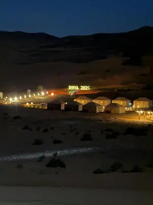 a night view of a beach with a baja stars sign at Morocco Desert Camp in Merzouga