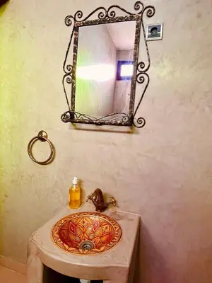 a bathroom with a sink and a mirror on the wall at Palais Aya in Oulad Akkou
