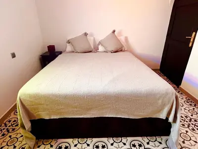 a bed with two pillows on it in a room at Palais Aya in Oulad Akkou