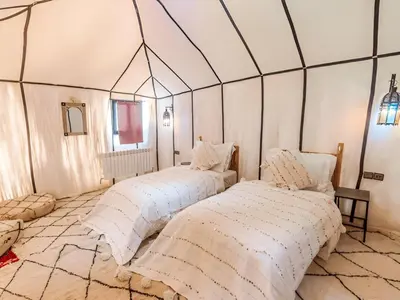 two beds in a room with a dome ceiling at Arsura Luxury Camp in Merzouga