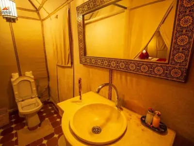 a bathroom with a sink and a toilet at Arsura Luxury Camp in Merzouga