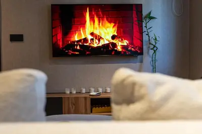 a living room with a fire in a fireplace at Modern Loft in City Center in Oulad Akkou