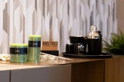 a table with two candles and a bottle of alcohol at Modern Loft in City Center in Oulad Akkou