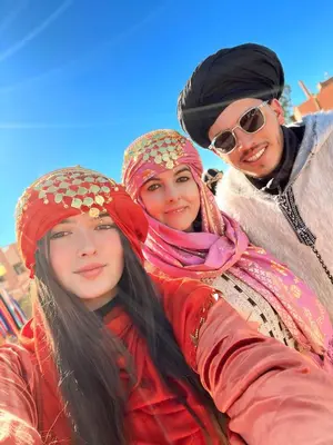 a group of three women posing for a picture at Merzouga Standard Camp in Merzouga
