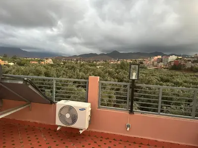 a fan on a balcony with a view of a city at Private Villa, Pool, Gym, Atlas View in Ourika