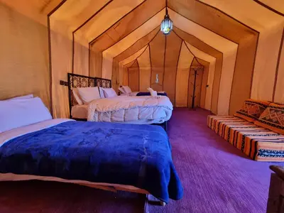 a bedroom with two beds in a room at Aziz luxury camp in Merzouga