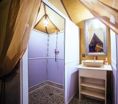 a bathroom with a shower and a sink at Aziz luxury camp in Merzouga