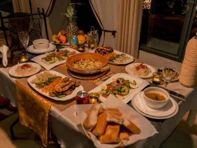 a table with plates of food on it at Global Desert Luxury Camp in Merzouga