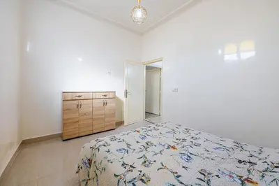 a bedroom with a bed and a dresser and a mirror at Private Villa with Pool and Hammam Marrakech in Oulad Akkou