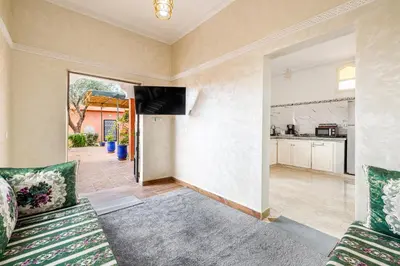 a living room with a couch and a view of a kitchen at Private Villa with Pool and Hammam Marrakech in Oulad Akkou