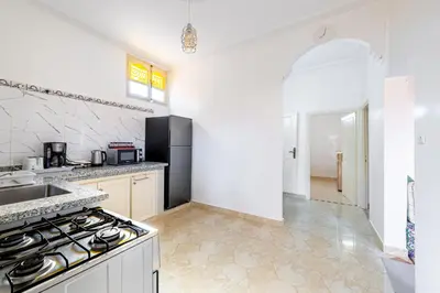 a white kitchen with a stove and a sink at Private Villa with Pool and Hammam Marrakech in Oulad Akkou