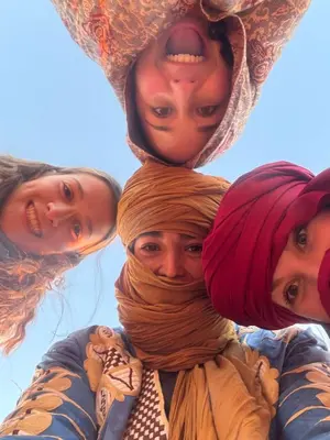 a group of three women piled on top of each other at Luxury camp desert in Merzouga
