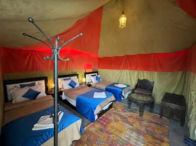 a room with two beds in a tent at Luxury camp desert in Merzouga