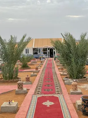 a long red carpet in front of a building at Luxury camp desert in Merzouga