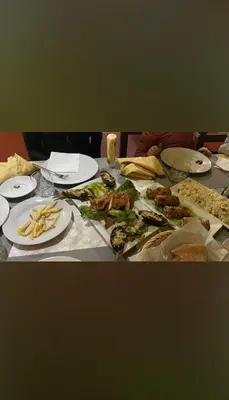 a table topped with plates of food and french fries at Luxury camp desert in Merzouga