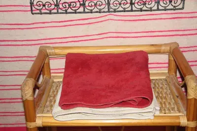 a red towel is sitting on a basket at dorada apartamento in Merzouga