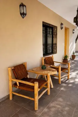 two chairs and a table on a patio at Dar Laydam in Aït Zat