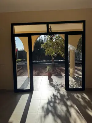 a room with a glass door with a potted plant at Dar Laydam in Aït Zat