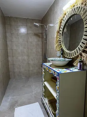 a bathroom with a sink and a mirror at Dar Laydam in Aït Zat