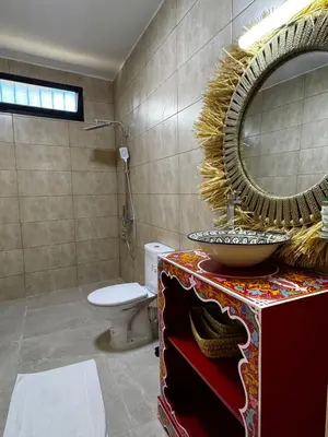 a bathroom with a sink and a mirror and a toilet at Dar Laydam in Aït Zat