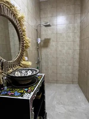 a bathroom with a sink and a mirror at Dar Laydam in Aït Zat