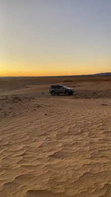 a car parked in the middle of a desert at Colorado Desert Camp in El Gouera