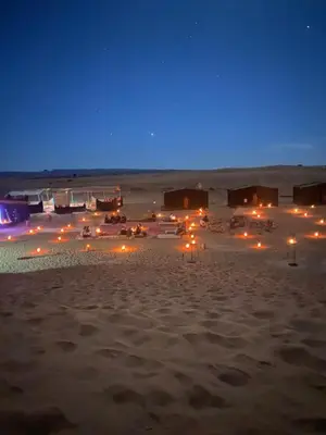 a group of lodges in the desert at night at Colorado Desert Camp in El Gouera