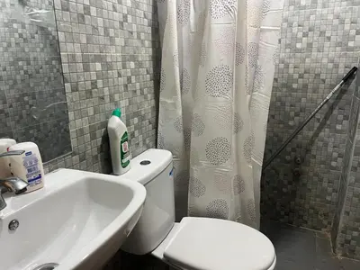 a bathroom with a toilet and a sink and a shower at Université luxe appart2 in Fès