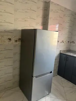 a refrigerator in the corner of a kitchen at Université luxe appart2 in Fès