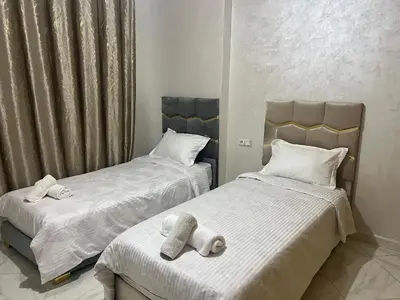 two beds with towels on them in a bedroom at Université luxe appart2 in Fès
