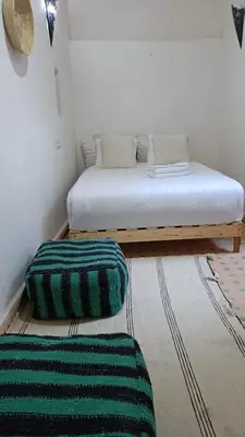 a bedroom with a bed and two pillows on the floor at chez dar Ayoub in Fès