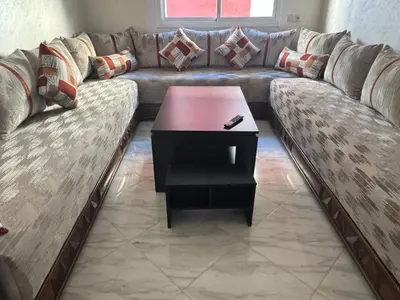 a couch with a coffee table in a living room at Darappart in Fès