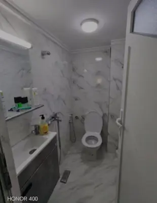 a bathroom with a toilet and a sink and a shower at Darappart in Fès