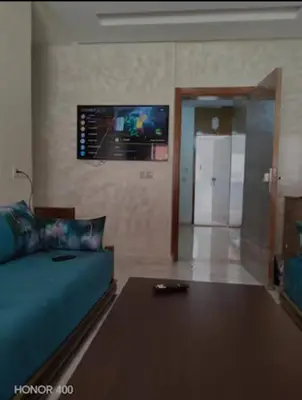 a living room with a couch and a flat screen tv at Darappart in Fès