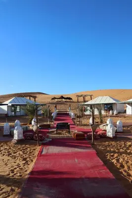 a red carpet in the middle of the desert at Amira Luxury Desert Camp in Merzouga