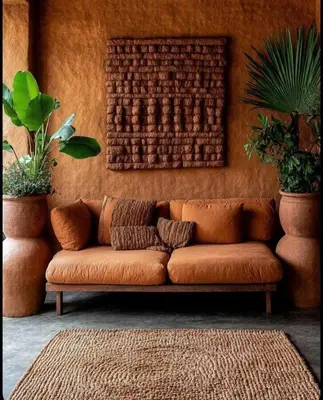 a brown couch sitting in a room with plants at Riad hibat fes in Fès