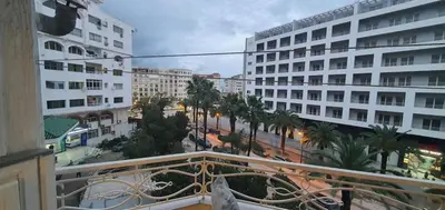 a view of a city with palm trees and buildings at Appartement tout confort sur la corniche à proximité plage in Oulad Akkou