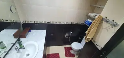 a small bathroom with a sink and a toilet at Appartement tout confort sur la corniche à proximité plage in Oulad Akkou