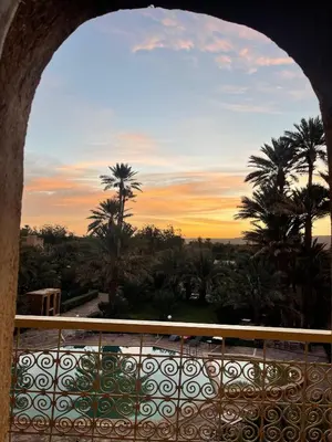 a view of the sunset from the balcony of a resort at Riad Ksar Assalassil Erfoud in Erfoud