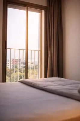 a bedroom with a bed and a large window at Luxury Apartment Prestigia Champ Cours Garden View in Fès