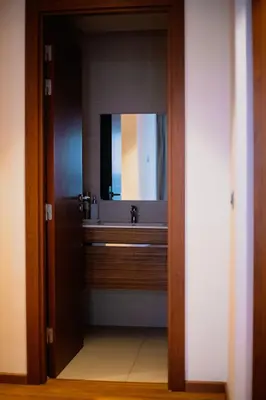 a bathroom with a sink and a mirror at Luxury Apartment Prestigia Champ Cours Garden View in Fès