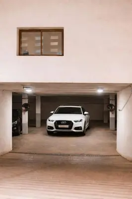 a white car is parked in a garage at Luxury Apartment Prestigia Champ Cours Garden View in Fès