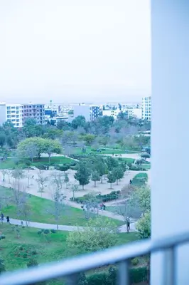a view of a park from a window at Luxury Apartment Prestigia Champ Cours Garden View in Fès