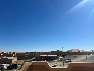 a view of a parking lot with mountains in the background at Dream Merzouga Rooms in Merzouga